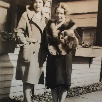 Marguerite Cox? and Bea Finch: in front of Margurite's home next to Drug Store facing Mason St.