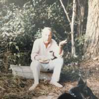          Burr Tillstrom on a log with dog
   
