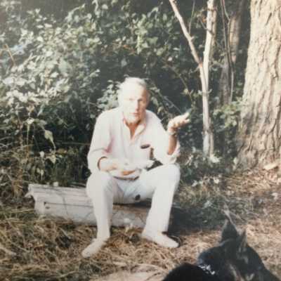 Burr Tillstrom on a log with dog
