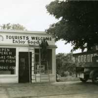          Sign painter working on front facade of Diepenhorst fish market
   