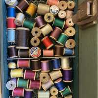          Wooden spools of silk and cotton thread used for puppet making and repair of Burr Tillstrom’s hand made puppets
   