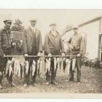 Four Men Holding Fish