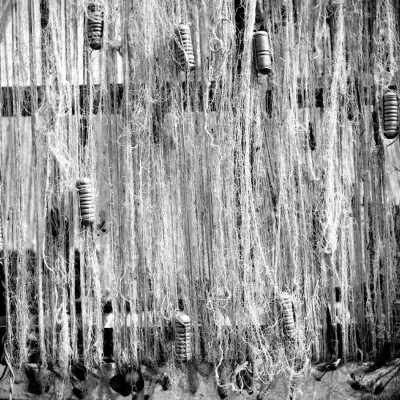 Floats attached to gill nets drying on a reel. Saugatuck circa 1944