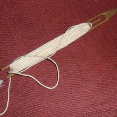 Photo of netting needle loaded with twine