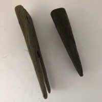         Wooden 19 th century logging pins; Side view of two hand carved 19 th century logging pins 
   