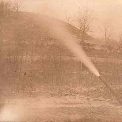 Oscar Orndoff [1868-1925] "blowing the drip" from an oil and gas well