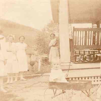 Sellers Burdette Carpenter [in wagon] and Charles Leslie Carpenter [pulling wagon]