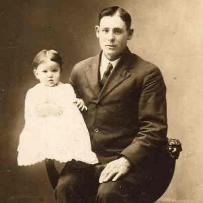 Benjamin Franklin Huffman Jr. holding one of his children