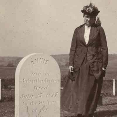 Catharine (Anderson) Watson with the tombstone of her mother, Anna (Howshow) Anderson