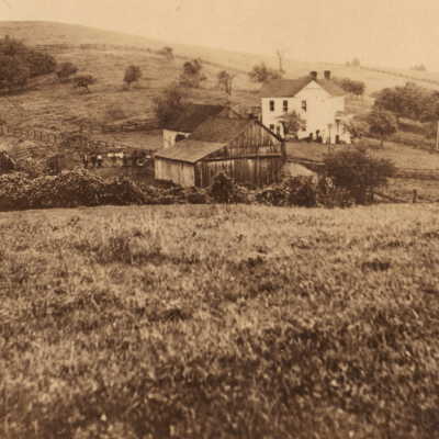 Thomas Kent log cabin [left-foreground] and the home of his grandson Spencer B. Kent [white house]