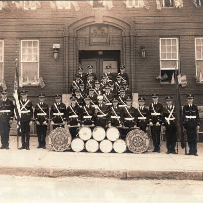 American Legion James Farrell Post 330 Drum and Bugle Corps posed in front of the Armory