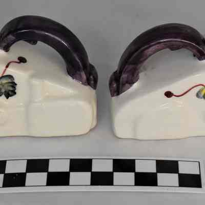 Back and size comparison of iron salt and pepper shakers.