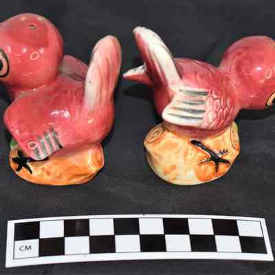 Other side and size comparison of red birds salt and pepper shakers.