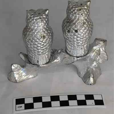 Back and size comparison of owl salt and pepper shakers.