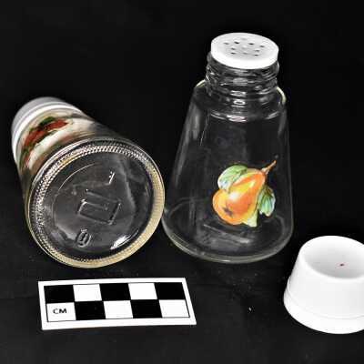 Removable plastic cap and unidentified design on base