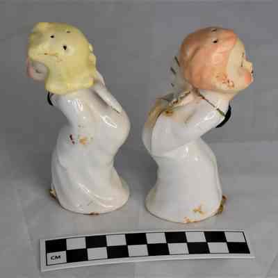 Other side and size comparison of kissing angels salt and pepper shakers.