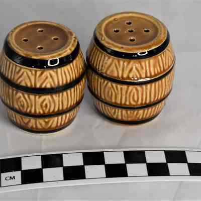 Back and size comparison of whiskey barrel salt and pepper shakers.