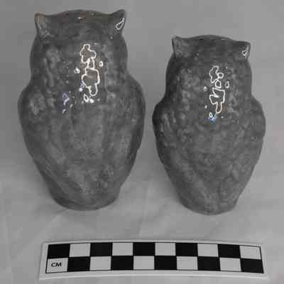 Back and size comparison of owl salt and pepper shakers.
