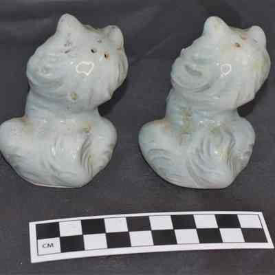 Back and size comparison of cat salt and pepper shakers.