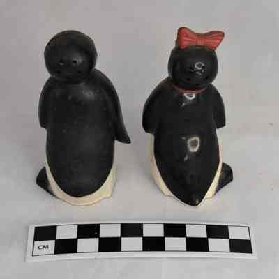 Back and size comparison of Willie and Millie salt and pepper shakers.