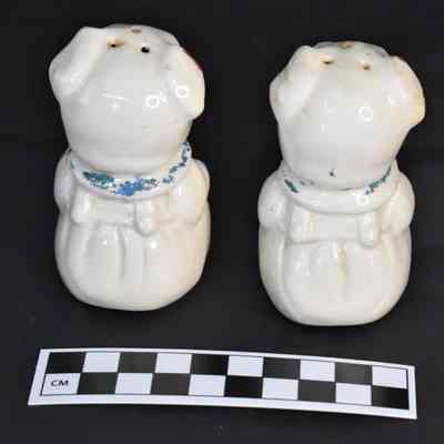 Back and size comparison of pigs salt and pepper shakers.