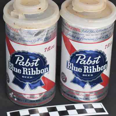 Back and size comparison of beer can salt and pepper shakers.