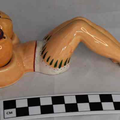 Size comparison of nude woman salt and pepper set.