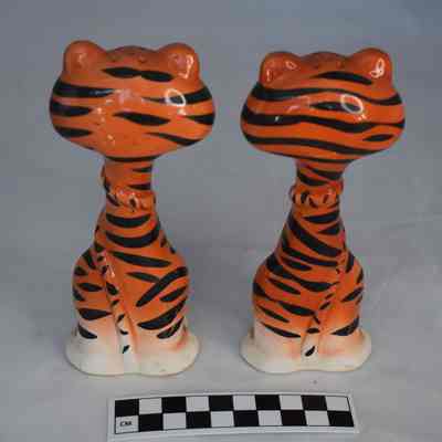 Back and size comparison of the tiger salt and pepper shakers.