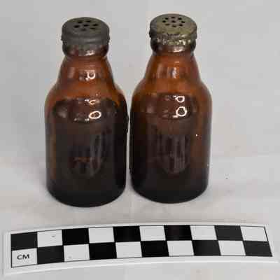 Back and size comparison of beer bottle shakers.