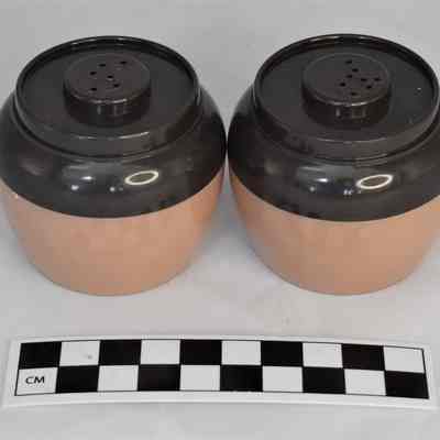 Back and size comparison of bean pot salt and pepper shakers.