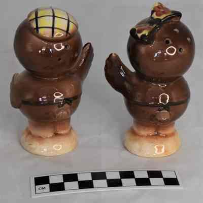 Back and size comparison of owl salt and pepper shakers.