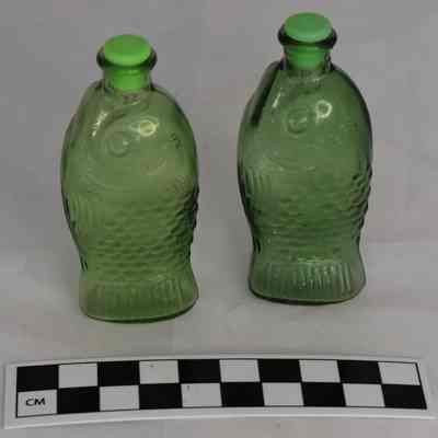 Other side and size comparison of bitters bottles salt and pepper shakers.
