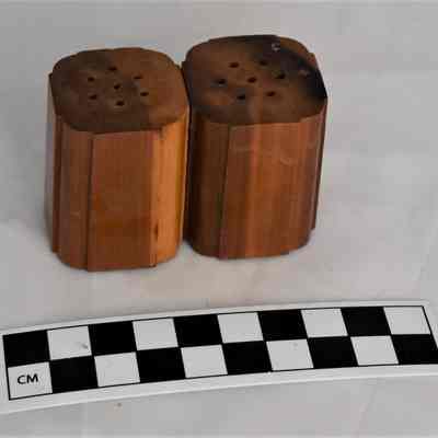 Back and size comparison of wooden salt and pepper shakers.