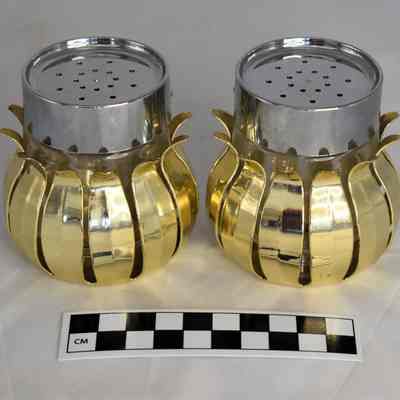 Other side and size comparison of pineapple salt and pepper shakers.