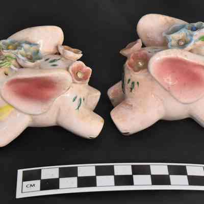 Other side and size comparison of pink elephant salt and pepper shakers.