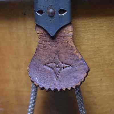 The four-pointed star on the leather pieces.