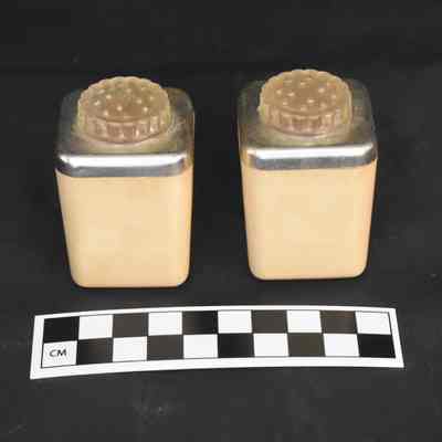 Back and size comparison of the Guantanamo Bay salt and pepper shakers.