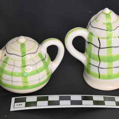 Back and size comparison of teapot and coffee pot shakers.