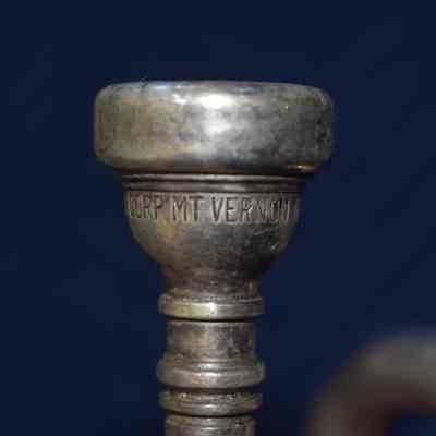 The second part of the inscription on the mouthpiece, which says "CORP MT VERNON".