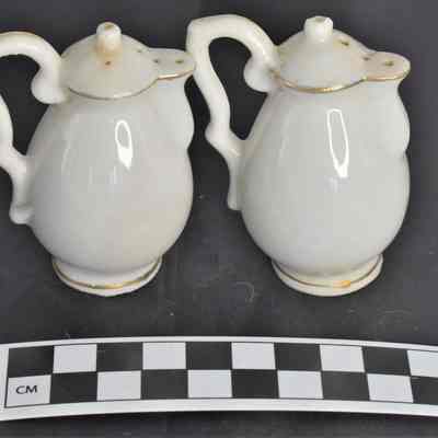Back and size comparison of Cape Cod salt and pepper shakers.
