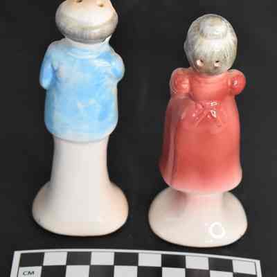 Back and size comparison of Grandma and Grandpa salt and pepper shakers.
