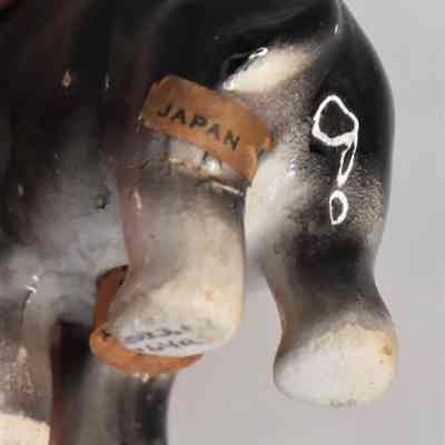 Label marked "Japan" on back left leg of salt shaker.