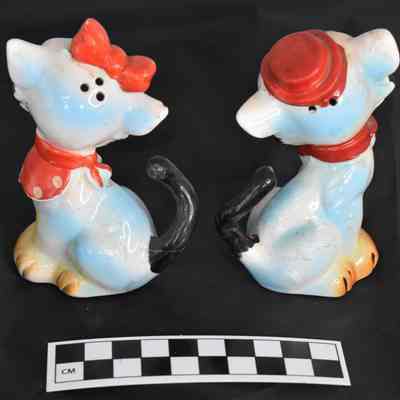 Back and size comparison of cats salt and pepper shakers.