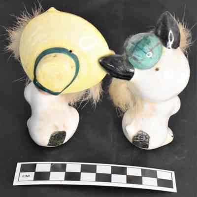 Back and size comparison of cats salt and pepper shakers.