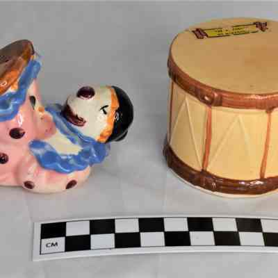 Other side and size comparison of clown and drum shakers.