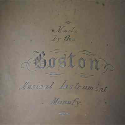 The "Made by the Boston Musical Instrument Manufy." inscription on the side of the bell.