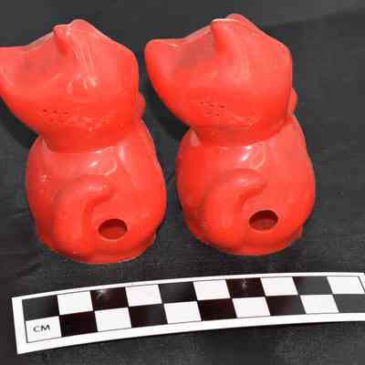 Back and size comparison of cat salt and pepper shakers.
