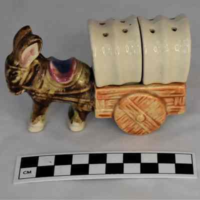 Other side and size comparison of donkey and cart salt and pepper set.