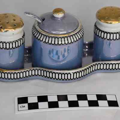 Other side and size comparison of blue and gold Lusterware condiment set.