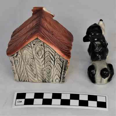Back and size comparison of dog and doghouse salt and pepper shakers.